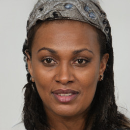 Joyful black young-adult female with long  brown hair and brown eyes