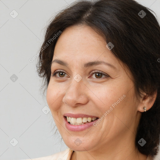 Joyful white adult female with medium  brown hair and brown eyes