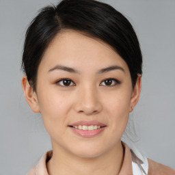 Joyful asian young-adult female with medium  brown hair and brown eyes