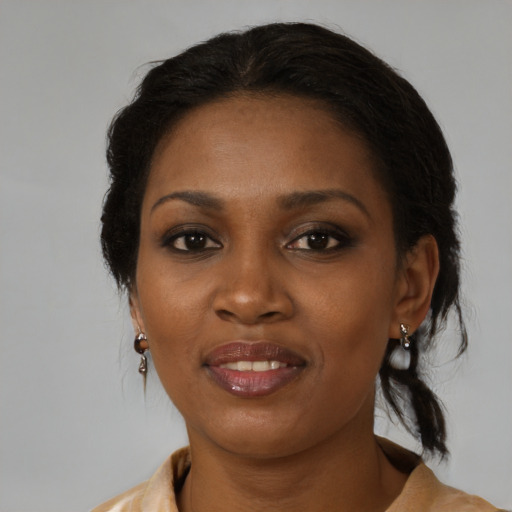Joyful black adult female with medium  brown hair and brown eyes