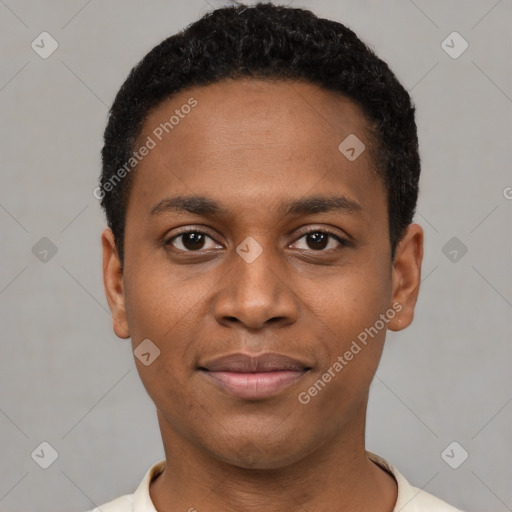 Joyful black young-adult male with short  black hair and brown eyes