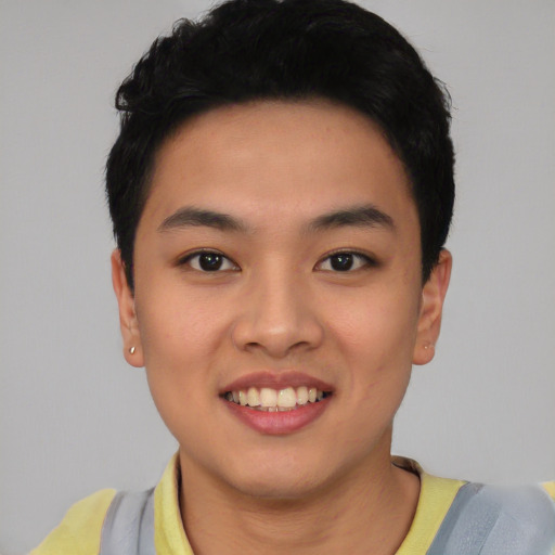 Joyful asian young-adult male with short  black hair and brown eyes