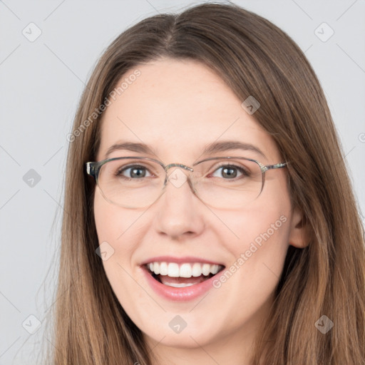 Joyful white young-adult female with long  brown hair and brown eyes