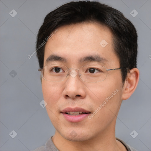 Joyful asian young-adult male with short  brown hair and brown eyes