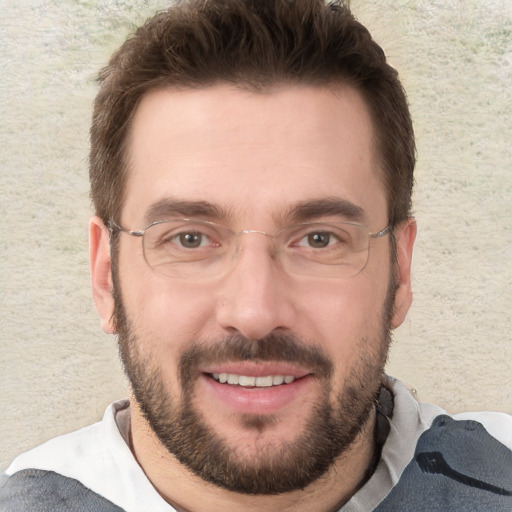 Joyful white adult male with short  brown hair and brown eyes