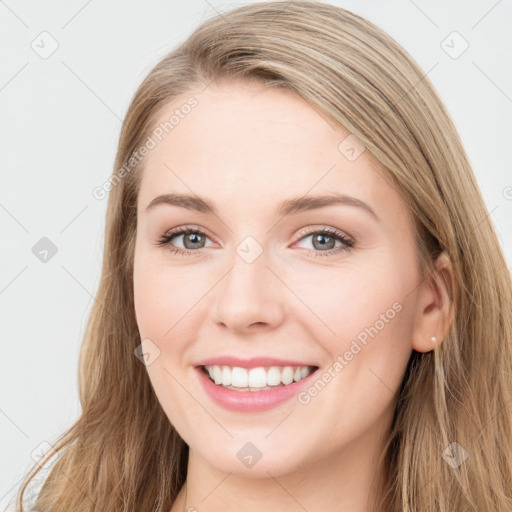 Joyful white young-adult female with long  brown hair and blue eyes