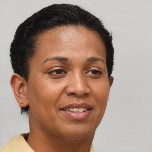 Joyful latino adult female with short  brown hair and brown eyes