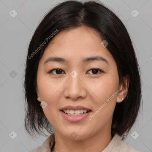 Joyful asian adult female with medium  brown hair and brown eyes