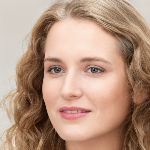 Joyful white young-adult female with long  brown hair and blue eyes