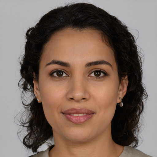 Joyful latino young-adult female with medium  brown hair and brown eyes