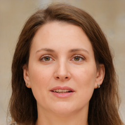 Joyful white young-adult female with long  brown hair and green eyes