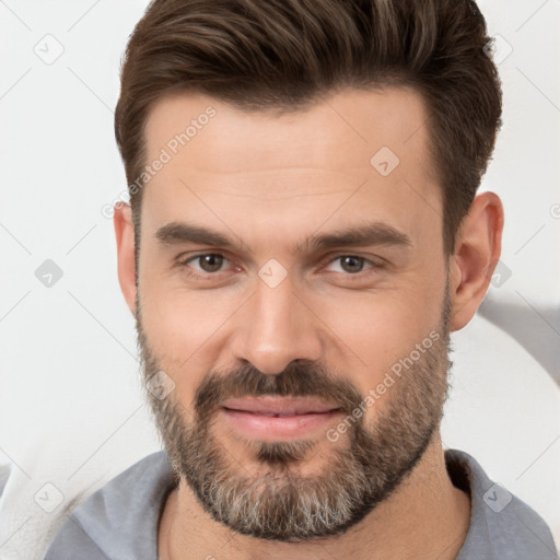 Joyful white adult male with short  brown hair and brown eyes