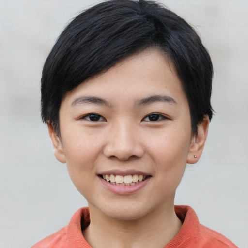 Joyful asian young-adult female with short  black hair and brown eyes