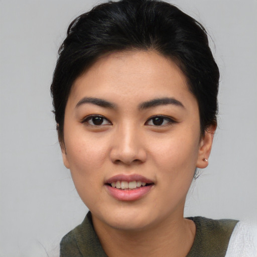 Joyful asian young-adult female with medium  black hair and brown eyes
