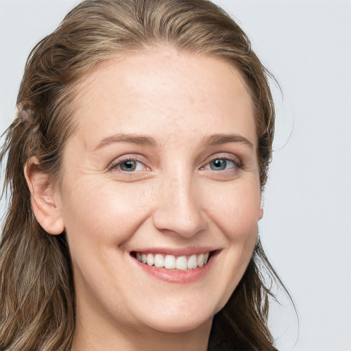 Joyful white young-adult female with long  brown hair and blue eyes