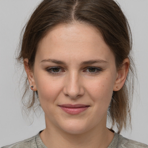 Joyful white young-adult female with medium  brown hair and grey eyes