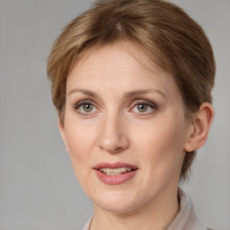 Joyful white young-adult female with medium  brown hair and grey eyes