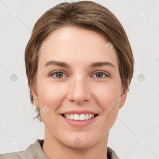 Joyful white young-adult female with short  brown hair and grey eyes