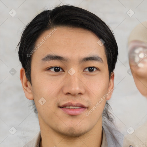 Joyful asian young-adult male with short  black hair and brown eyes