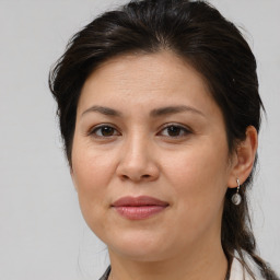 Joyful white adult female with medium  brown hair and brown eyes