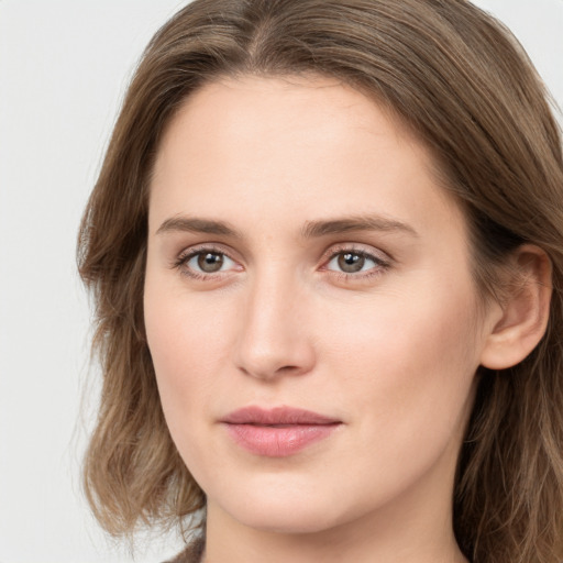 Joyful white young-adult female with long  brown hair and grey eyes