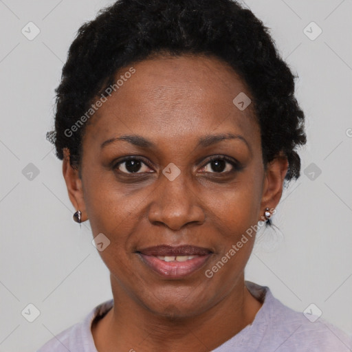 Joyful black adult female with short  black hair and brown eyes