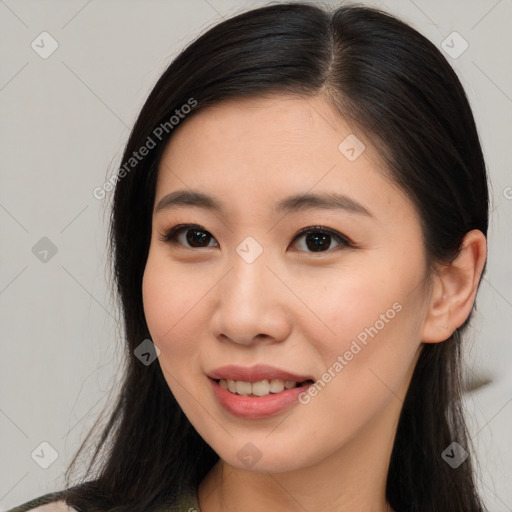 Joyful asian young-adult female with long  brown hair and brown eyes