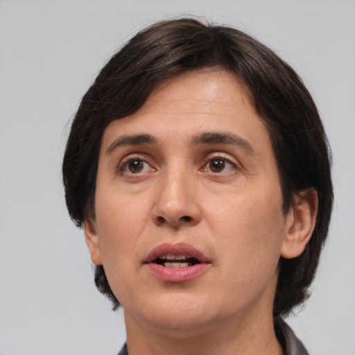 Joyful white adult female with medium  brown hair and brown eyes