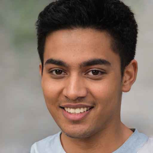 Joyful latino young-adult male with short  brown hair and brown eyes