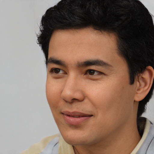 Joyful asian young-adult male with short  black hair and brown eyes