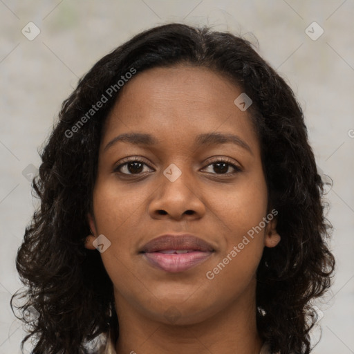 Joyful black young-adult female with long  brown hair and brown eyes