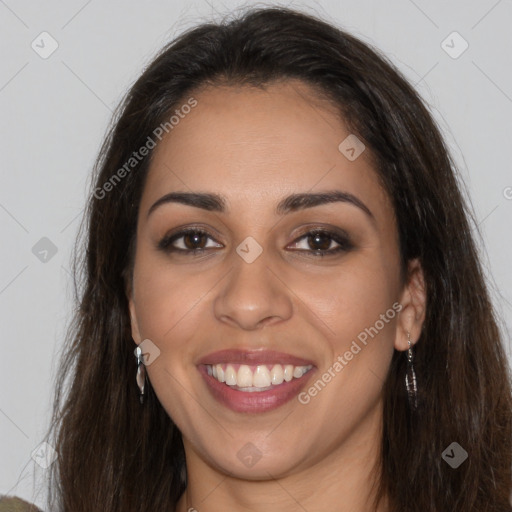 Joyful latino young-adult female with long  brown hair and brown eyes