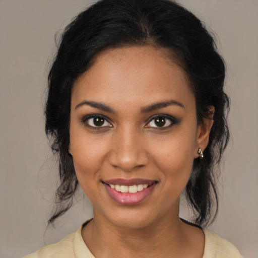 Joyful black young-adult female with medium  brown hair and brown eyes