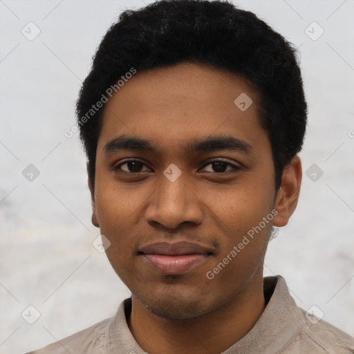 Joyful black young-adult male with short  black hair and brown eyes