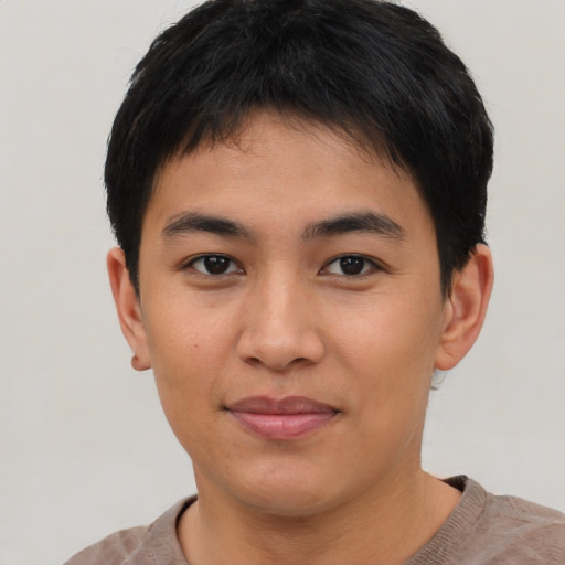 Joyful asian young-adult male with short  brown hair and brown eyes
