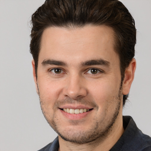 Joyful white young-adult male with short  brown hair and brown eyes