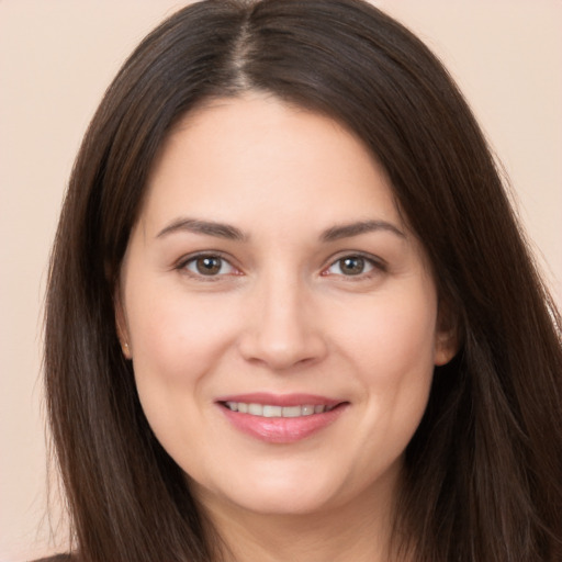 Joyful white young-adult female with long  brown hair and brown eyes