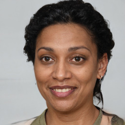 Joyful latino adult female with short  brown hair and brown eyes