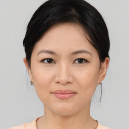 Joyful asian young-adult female with medium  brown hair and brown eyes