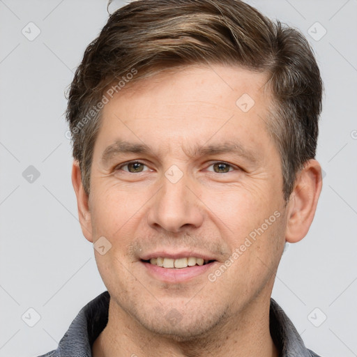 Joyful white adult male with short  brown hair and grey eyes