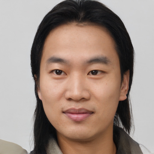 Joyful asian young-adult male with medium  black hair and brown eyes