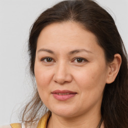 Joyful white adult female with long  brown hair and brown eyes