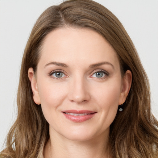 Joyful white young-adult female with long  brown hair and grey eyes