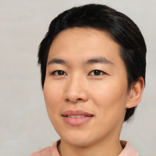 Joyful asian young-adult female with short  black hair and brown eyes