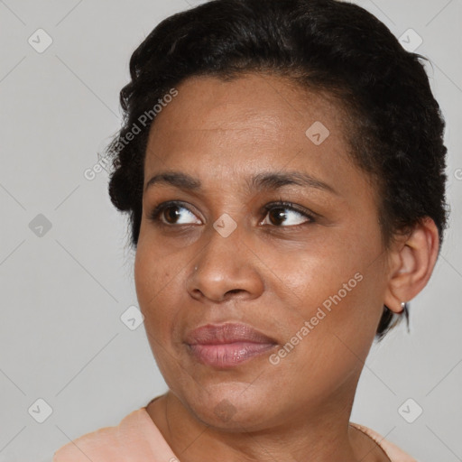 Joyful black young-adult female with short  black hair and brown eyes