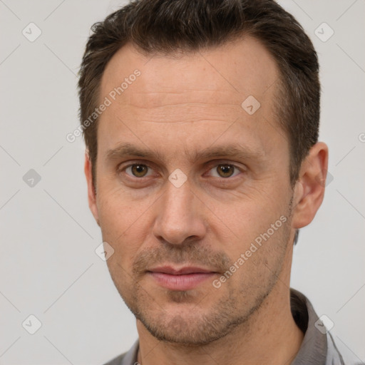 Joyful white adult male with short  brown hair and brown eyes