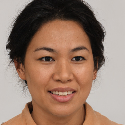 Joyful asian adult female with medium  brown hair and brown eyes
