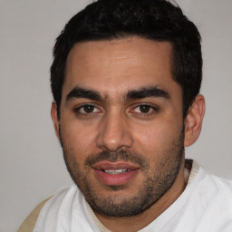 Joyful white young-adult male with short  black hair and brown eyes
