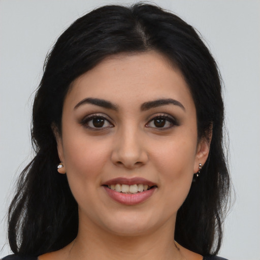 Joyful latino young-adult female with long  black hair and brown eyes