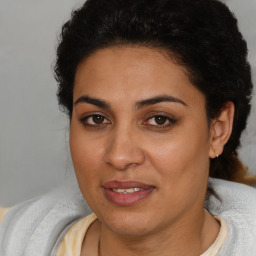 Joyful latino young-adult female with short  brown hair and brown eyes